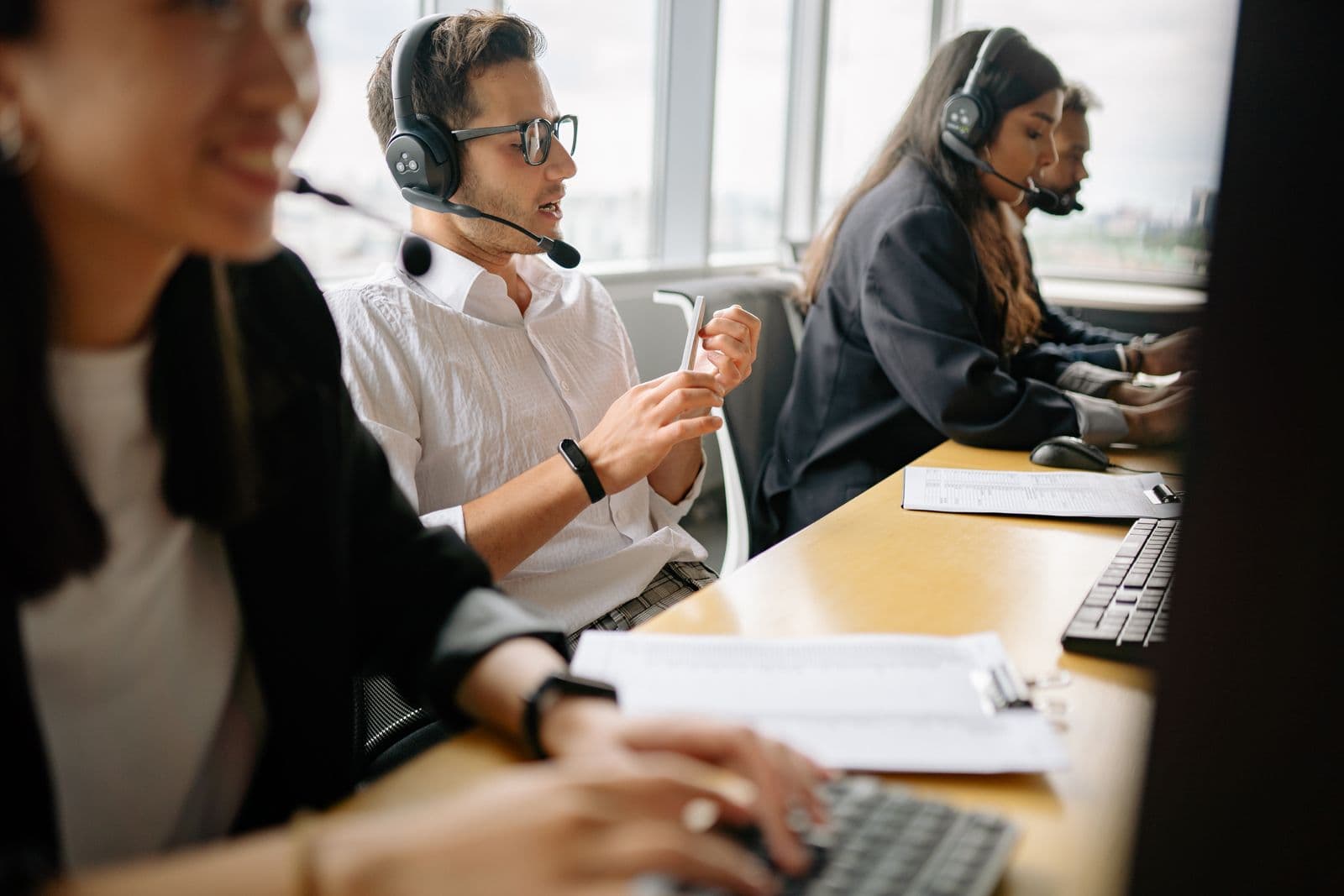 Phone team working outbound campaigns with headsets